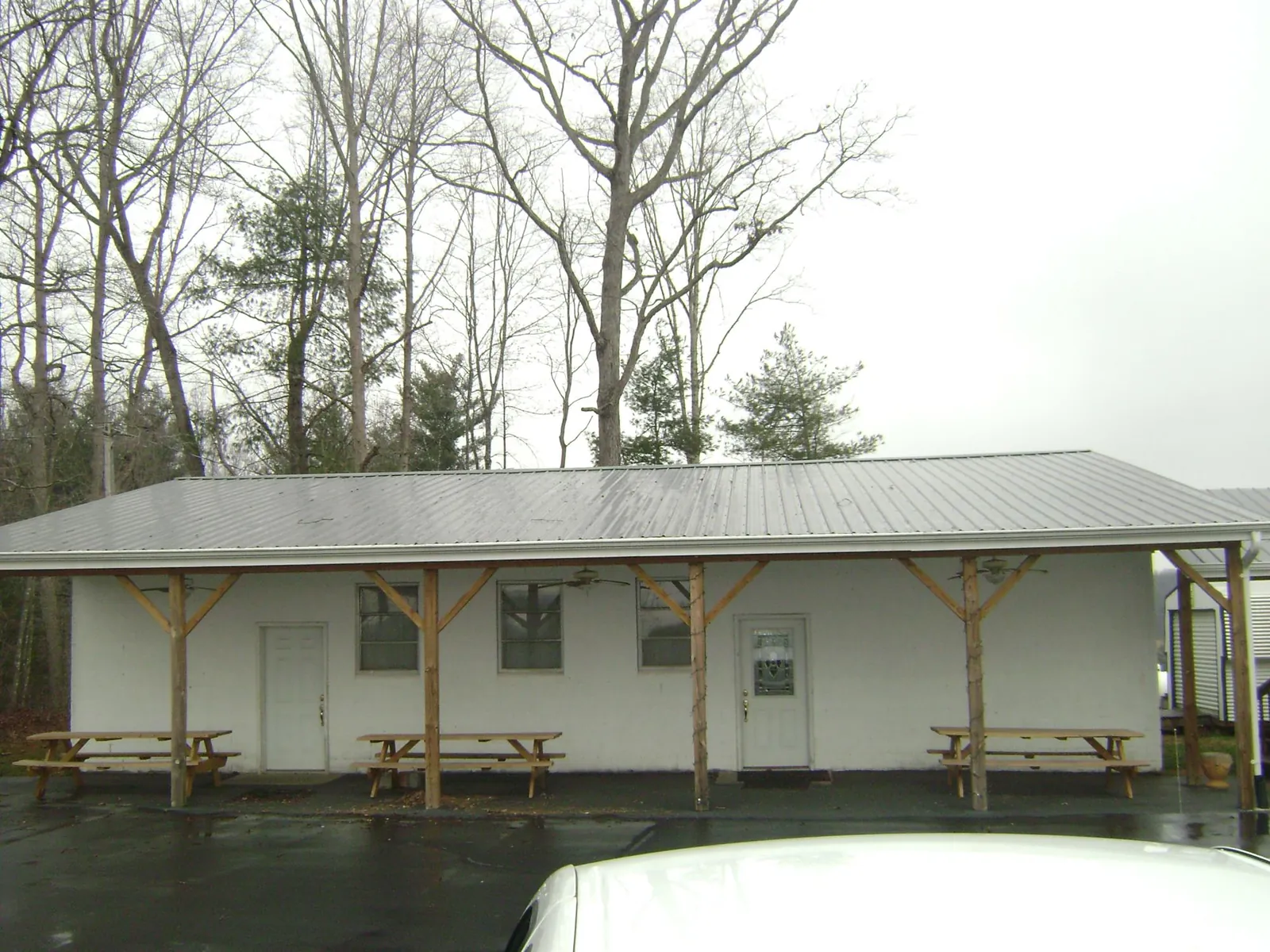 Gray metal roof over a block building with a timber post porch in Montara